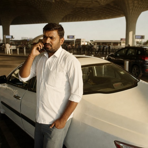 A cab driver waiting at an airport kerb